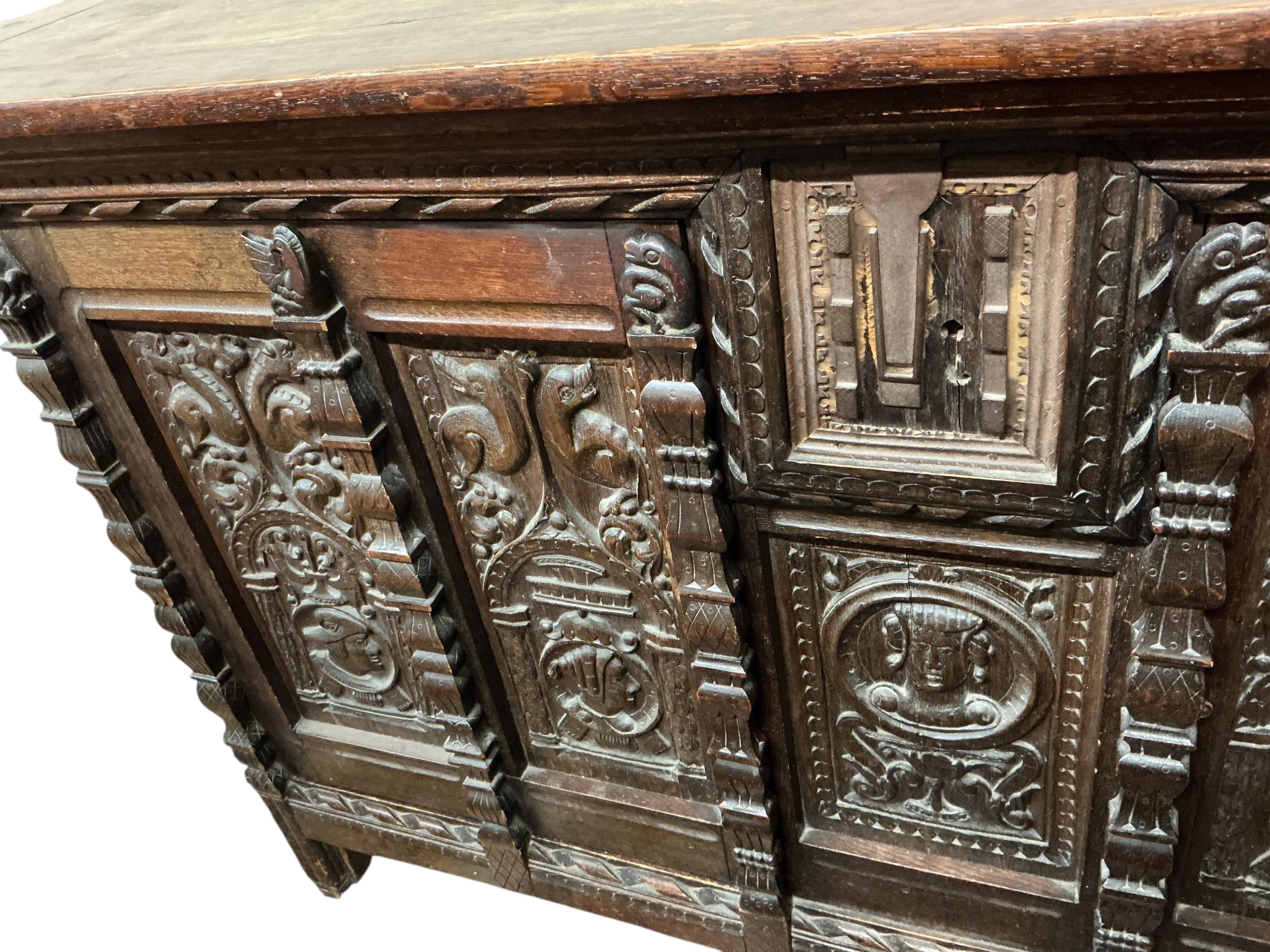A 17th century style carved oak side coffer, width 145cm, depth 47cm, height 86cm